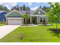 Charming craftsman-style home with a well-manicured lawn and inviting front porch at 217 Quimby Hill Dr, Huger, SC 29450