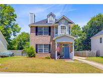 Charming two-story brick home with a landscaped yard, covered entry, and inviting curb appeal at 2404 Fulford Ct, Mount Pleasant, SC 29466