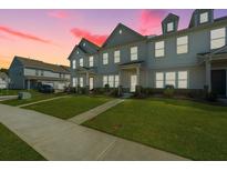 Charming townhome featuring a manicured lawn, beautiful architectural details, and a welcoming curb appeal at 286 Godwit Dr, Summerville, SC 29486