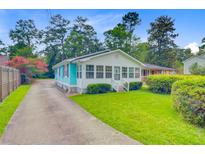 Charming home with a well-manicured lawn, quaint front porch, and inviting curb appeal at 316 Simmons Ave, Summerville, SC 29483