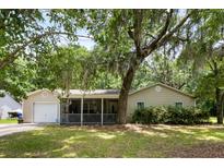 Charming single-story home with a covered porch, lush lawn, and a mature, shade-providing tree at 3347 Walter Drive, Johns Island, SC 29455
