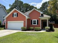 Charming single-story home with a manicured lawn, two-car garage and inviting front entrance at 350 Cypress Walk Way, Wando, SC 29492