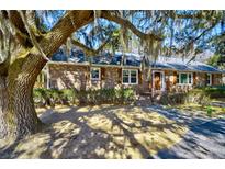 Charming brick home with meticulous landscaping and inviting front entrance at 4715 Highway 165, Meggett, SC 29449