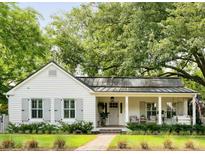 Charming single-story home showcasing beautiful landscaping, a cozy front porch, and classic white siding at 509 Klein St, Mount Pleasant, SC 29464