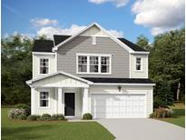 Charming two-story home with a manicured lawn, attached garage, and beautifully contrasting neutral color scheme at 5313 Bending Flats Way, Summerville, SC 29485