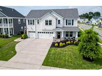 Beautiful two-story home featuring a three-car garage, landscaped yard, and inviting front porch at 558 Pendleton Dr, Moncks Corner, SC 29461