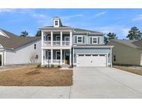 Charming two-story home with a welcoming front porch and a two-car garage, providing ample space and curb appeal at 772 Maynard Ln, Summerville, SC 29486