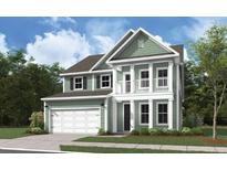 Charming two-story home with a welcoming porch, lush lawn, and attached garage at 785 Maynard Ln, Summerville, SC 29486