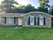 Charming brick home with a yellow front door and black shutters; perfect for curb appeal at 980 Margaret Dr, Ladson, SC 29456