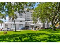 Beautiful multi-story building with lush landscaping and ample parking for residents and guests at 1 King # 702, Charleston, SC 29401