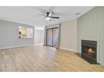 Bright living room with hardwood floors, ceiling fan and fireplace provides a comfortable living space at 1001 Waterwood Dr, Goose Creek, SC 29445