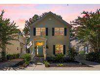 Charming two-story home with a colorful door, manicured landscaping, and inviting front porch at 1033 Mathis Ferry Rd, Mount Pleasant, SC 29464