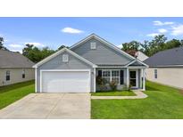 Charming single-Gathering home with a well-maintained lawn and attached garage, perfect for suburban living at 106 Maypop Dr, Goose Creek, SC 29445