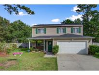Charming two-story home with a manicured lawn, green shutters, and a welcoming front porch at 106 Sioux Ct, Summerville, SC 29483