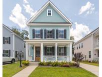Charming two-story home with a welcoming front porch and well-manicured lawn at 1150 Oak Bluff Ave, Charleston, SC 29492
