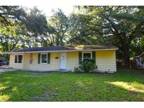 Charming single-story home with a well-maintained lawn and mature trees at 1203 Hawthorne Rd, Hanahan, SC 29410