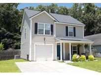 Charming two-story home featuring a welcoming front porch and a one-car garage at 122 Avalon Rd, Summerville, SC 29483