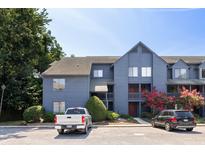 Multi-story home exterior with blue siding and parked vehicles, showcasing curb appeal at 1530 Fort Johnson Rd # 2E, Charleston, SC 29412