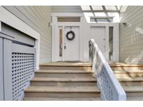 Inviting front door with a wreath and steps leading up to a covered porch area, perfect for guests at 1723 Live Oak Park, Seabrook Island, SC 29455