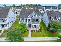 Charming two-story home with a double porch and manicured lawn at 1726 Winfield Way, Charleston, SC 29414