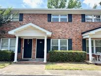 Traditional brick townhouse with a covered entrance and well-maintained landscaping at 1820 Mepkin Rd # 1019, Charleston, SC 29407