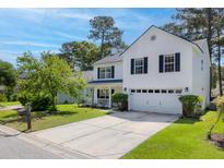 Charming two-story home boasts a manicured front lawn and inviting curb appeal at 207 Breckingridge Dr, Ladson, SC 29456