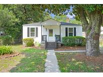 Charming, quaint single-story home featuring a walkway, black shutters, and a well-maintained front yard at 2608 Seymour Ave, North Charleston, SC 29405