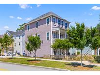 Charming three-story home with a landscaped yard and inviting front porch at 4419 Louisa Lane Ln, North Charleston, SC 29405