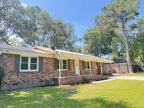 Charming brick home with well-maintained lawn and covered front porch at 449 Estates Dr, Walterboro, SC 29488