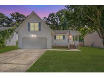 Charming two-story home with a manicured lawn and a two-car garage at 5052 Hidden Forest Ln, North Charleston, SC 29420