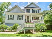 Charming two-story home featuring a welcoming front porch and beautifully landscaped yard at 914 Dill Ave, Charleston, SC 29412