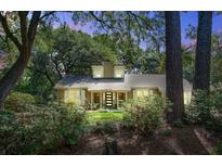 Inviting exterior of a home with a well-manicured lawn and lush landscaping provides privacy at 1052 Yorktown Dr, Charleston, SC 29412