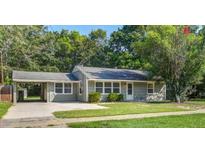 Charming single-story home with a carport, gray siding, and a well-maintained front yard at 1112 Yeamans Hall Rd, Hanahan, SC 29410