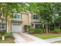 Charming two-story townhouse with an attached garage and well-manicured front yard at 114 Grand Palm Ln, Summerville, SC 29485