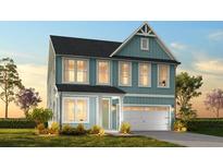 Charming two-story home featuring a blue exterior, a well-manicured lawn, and an attached two-car garage at 1219 Homecoming Blvd # Cc1-27, Ravenel, SC 29470