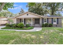 Charming brick home featuring a well-manicured lawn and mature landscaping at 131 Wedgewood Cir, Goose Creek, SC 29445