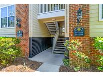 Apartment building entrance with brick accents, unit numbers and exterior lighting at 1600 Long Grove Dr # 1115, Mount Pleasant, SC 29464
