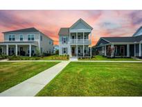Charming two-story home with a double front porch and manicured lawn at 203 Symphony Ave, Summerville, SC 29486