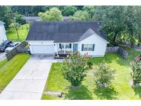 Charming single-story home with a lovely front yard and an attached garage, complemented by mature trees at 229 Lindy Creek Rd, Goose Creek, SC 29445