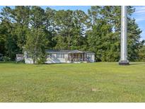 Well maintained single-story home with vinyl siding and a spacious front yard at 250 W Medina St, Summerville, SC 29483
