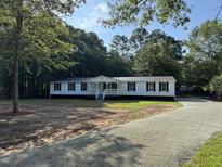Charming single story home with a welcoming front porch and well maintained landscape at 260 Lake Dr, Summerville, SC 29483