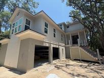 Inviting two-story home featuring large windows and open garage space at 2706 Old Oak Walk, Seabrook Island, SC 29455
