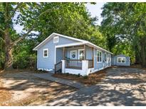 Charming blue bungalow with a welcoming front porch and lush landscaping at 2924 Chicora Ave, North Charleston, SC 29405
