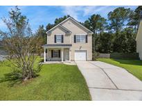 Charming two-story home with well-manicured lawn and inviting front porch at 307 Wilderland Ct, Moncks Corner, SC 29461