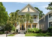 Charming two-story home with inviting porch, palm trees, and classic Southern style at 316 Bridgetown Pass, Mount Pleasant, SC 29464