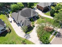 Stunning aerial view of a home with a circular driveway, lush landscaping, and manicured lawns at 3751 St Ellens Dr, Mount Pleasant, SC 29466