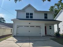 Beautiful two-story home featuring a large two-car garage and modern white facade at 4126 O'Hear Ave, North Charleston, SC 29406