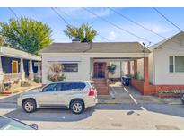 Charming single-story home with a brick and white facade and a convenient covered parking area at 6 Dewey St, Charleston, SC 29403