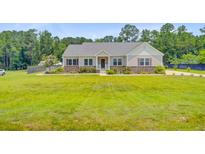 Charming single-story home featuring manicured landscaping, stone accents, and a welcoming front porch at 708 Tierra Loop, Summerville, SC 29483