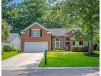 Charming brick home with a well-manicured lawn, two-car garage, and lovely landscaping at 808 Long Drive Rd, Summerville, SC 29485